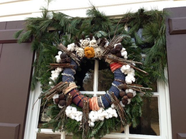 The Weaver's Shop, every Christmas Colonial Williamsburg "puts on the green" and they decorate. Often different shops and houses will add a theme to their decorating. This is the weaver's shop. Note unspun cotton and flax and strips of woven textiles.